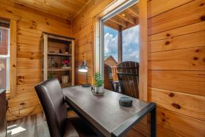 a dining room with a table and a window at Hibearnator in Sevierville +21 photos