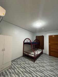 an empty room with a bunk bed in a room at Cozy Stay Near Bacnotan Plaza in Bacnotan