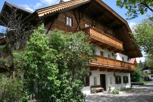 a large wooden house with a wooden balcony on it at Apperlehof in Villabassa