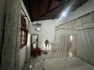 a room with a bed and a table and a mirror at White Swan Villa Unawatuna in Unawatuna +31 photos