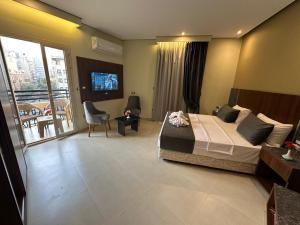 a hotel room with a bed and a balcony at Sama Hotel Oraby in Cairo