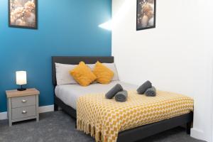 a bedroom with a bed with yellow and blue walls at Open Mind Property - 2 Beds & FREE Parking in Brockhurst
