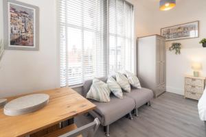 a living room with a couch and a table and a window at Host & Stay - Harbour Point in Ramsgate +3 photos