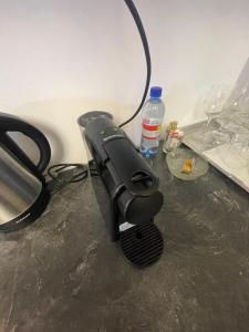 a hair dryer on a table with a bottle of water at Victoriei light studio in Bucharest