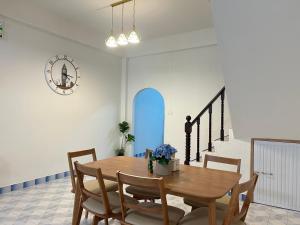a dining room with a wooden table and chairs at S Home Hat Yai - Entire House, Private Parking in Hat Yai