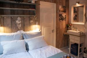 a bedroom with a white bed and a sink at Guesthouseamsterdam in Amsterdam +12 photos