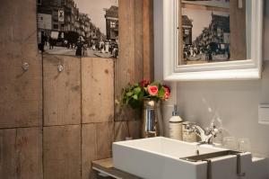 a bathroom with a sink and a picture on the wall at Guesthouseamsterdam in Amsterdam