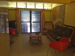 a living room with a couch and a table and chairs at Bayview Villa in Grand Baie