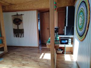 a room with a living room with a tv and a room with at Casa familiar chana 388 in Puerto Montt