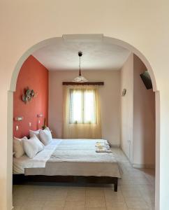 a bedroom with a large bed in an archway at Pansion Zaharoula in Fira +99 photos