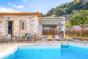 a villa with a swimming pool and a house at Villa Palataki I in Kardamyli +10 photos