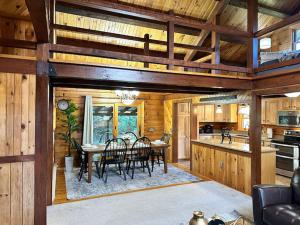 a kitchen and dining room with a table and chairs at Forest Tree Log Cabin in Middletown