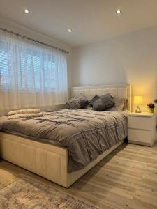 a bedroom with a large bed and a window at 2 Bedroom luxury apartments in Bristol