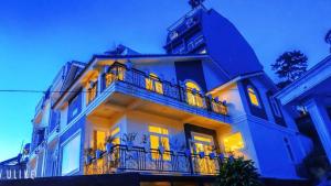 a large blue building with a balcony at KS Thanh Thùy in Xuan An
