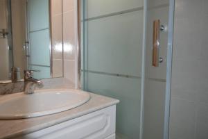 a bathroom with a sink and a glass shower at Maison 4 pièces ARGELES SUR MER AR300-027 in Argelès-sur-Mer +17 photos