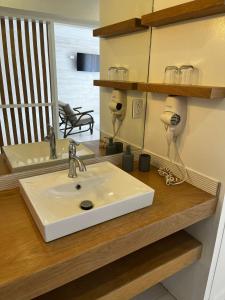 a bathroom counter with a white sink on it at The Monteray Hotel in Christ Church