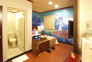 a room with a bedroom with a mickey mouse mural at Golden Swallow Hotel in Hsinchu City +24 photos