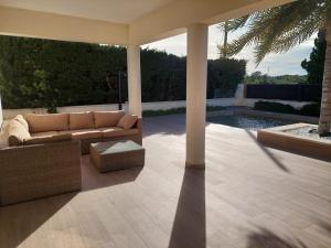a living room with a couch and a pool at Villa Nicole in Les tres Cales