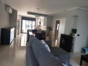 a living room with a couch and a kitchen at Villa Nicole in Les tres Cales