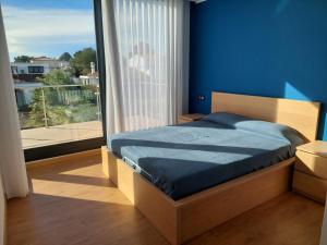 a bedroom with a bed and a large window at Villa Nicole in Les tres Cales +51 photos