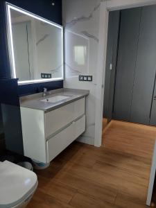 a bathroom with a sink and a toilet at Villa Nicole in Les tres Cales