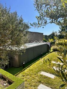 a building with a hot tub in a garden at Superbe Loft Spa Jacuzzi Cinema in Néris-les-Bains