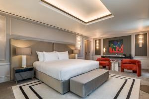 a bedroom with a large bed and a living room at Maison Albar - Amoure in Braga