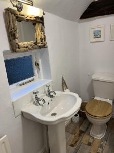 a bathroom with a sink and a toilet at Corner Cottage in Knaresborough +17 photos
