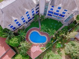 an overhead view of a pool in front of a building at Corridor Springs Hotel in Arusha