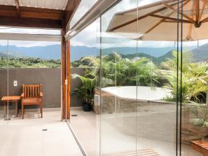 a glass house with a view at Jardim das Palmeiras II - Multipropriedade in Ubatuba