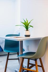 a table with two chairs and a potted plant at studios180 in Lexington