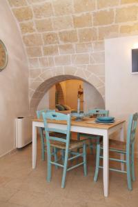 a table and chairs in a room with a brick wall at I Sottani in Monopoli