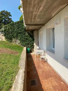 a patio with a table and chairs next to a building at Appartamenti Villa Andrea in Garda