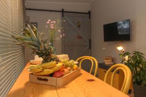 a wooden table with a box of fruit on it at Studio Šumbora in Peroj