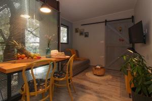 a living room with a table and a couch at Studio Šumbora in Peroj