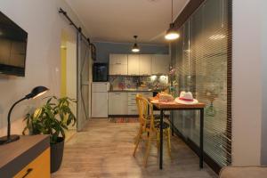 a kitchen with a table and chairs in a room at Studio Šumbora in Peroj +15 photos