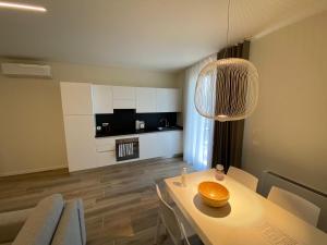 a living room with a table and chairs and a kitchen at Appartamenti Villa Andrea in Garda