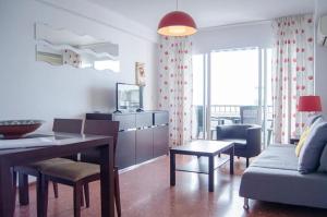 a living room with a couch and a table and chairs at APCOSTAS - Torre del Mar Playa - MALAGA in Torre del Mar