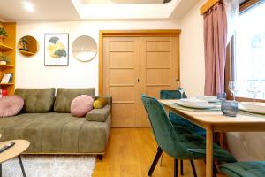 a living room with a couch and a table at The Wenceslas Loft in Prague