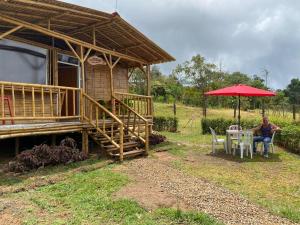 a woman sitting at a table in front of a house at Cabaña La Esperanza in San Bernardo +16 photos