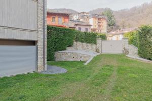 an empty yard next to a building with a garage at Frabosa Relax Garden- PVT Parking -10 Min Ski Station in Frabosa Sottana