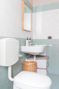 a bathroom with a white toilet and a sink at Frabosa Relax Garden- PVT Parking -10 Min Ski Station in Frabosa Sottana +21 photos