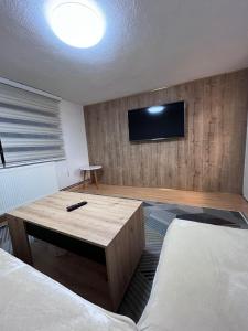 a hotel room with two beds and a flat screen tv at Sunset Apartment in Visoko