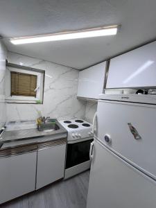a small kitchen with a stove and a sink at Sunset Apartment in Visoko