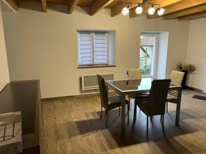 a dining room with a table and chairs at Chez Laura et Alex in Geville