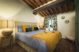 a bedroom with a bed and a chair at Villa Marra in SantʼAnna