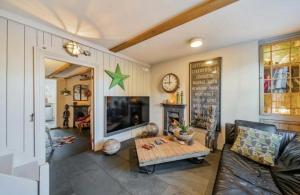 a living room with a couch and a table at Charming Dulwich Cottage in West Dulwich