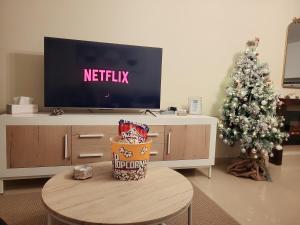 a living room with a tv and a christmas tree at Ribeles Luxury Flat in Arenas de Cabrales