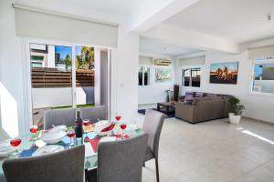 a dining room with a table and chairs at Halle Villa in Protaras