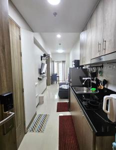 a kitchen with a sink and a counter top at Coast Residences - 1 Bedroom with Balcony near PICC, WTC, Star City & MOA in Manila +32 photos